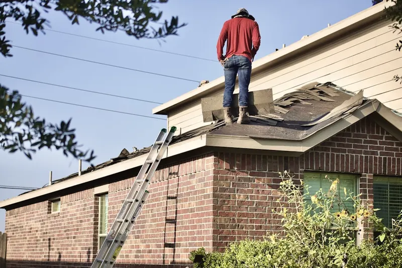 Professional roofer working on a residential roof in Scoutland
